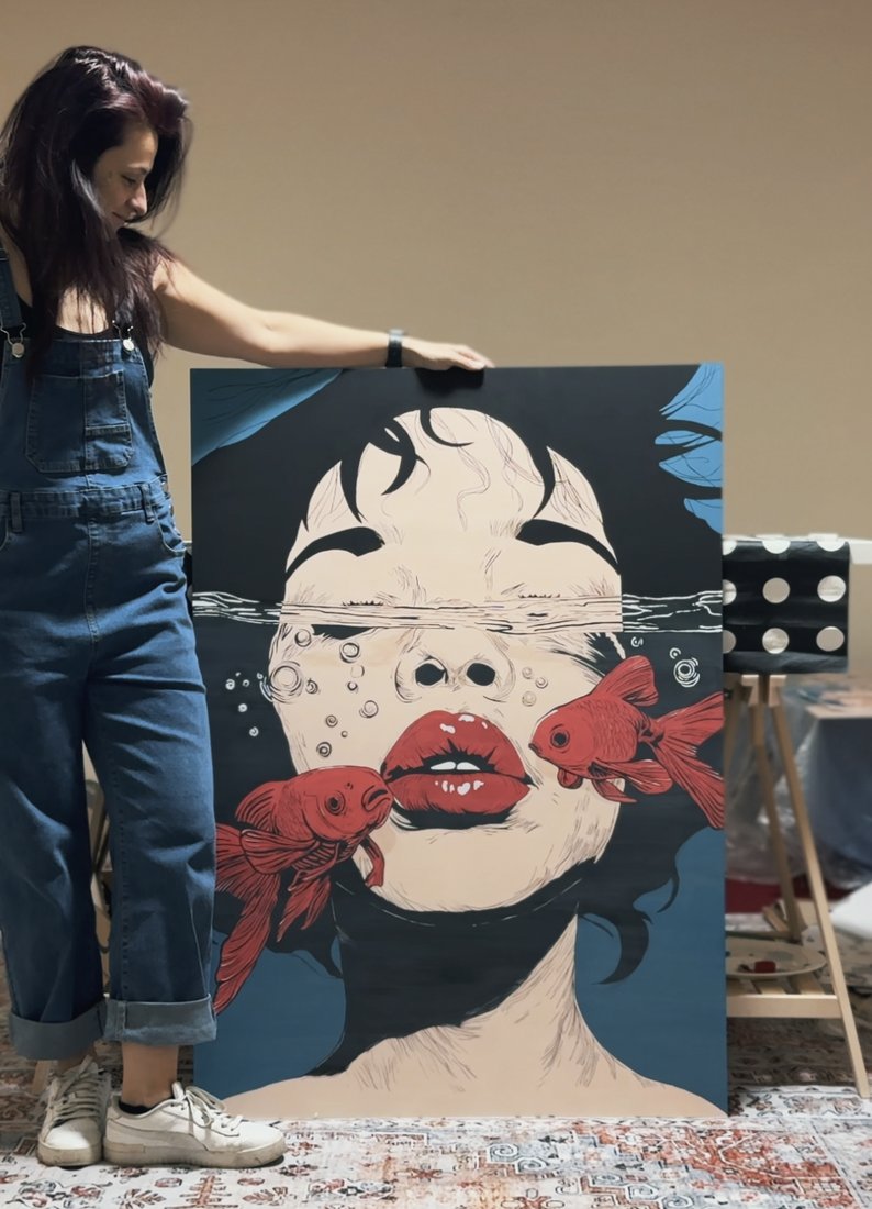 Elisa with her goldfish painting