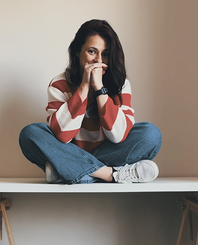 Elisa sitting cross-legged on a table