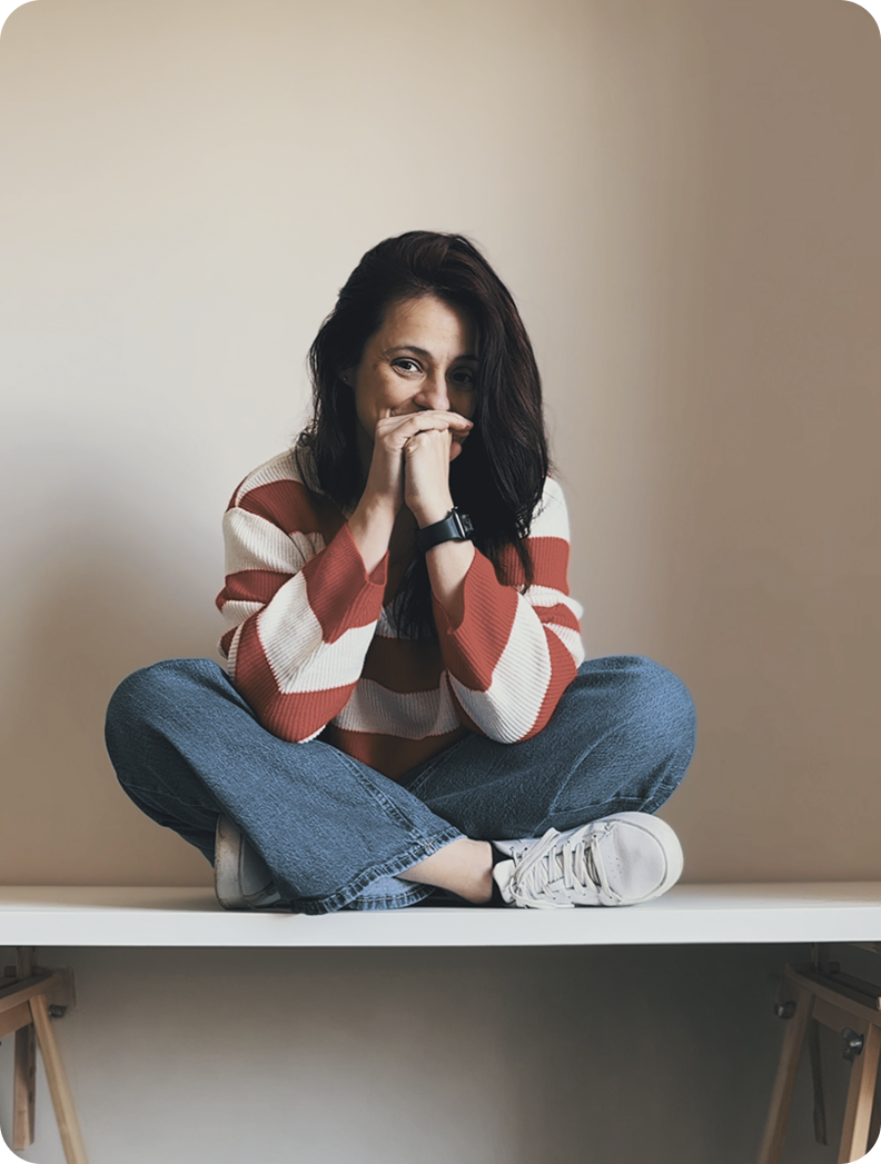 Elisa sitting cross-legged on a table