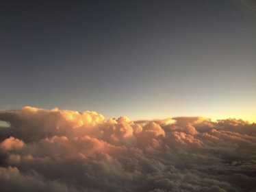 Above the clouds at sunset